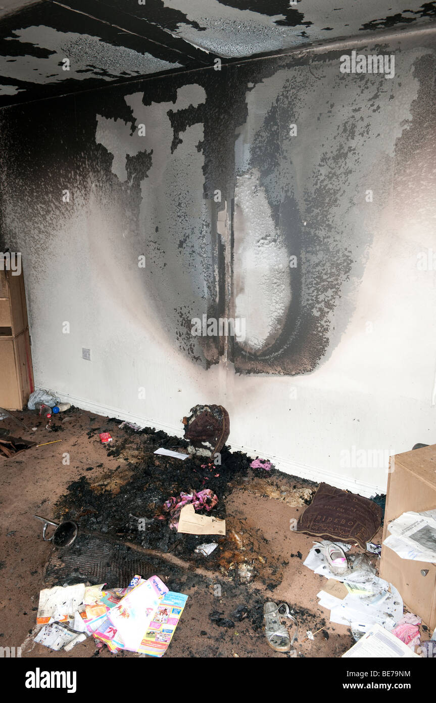 Burn pattern on lounge wall from settee fire started by discarded