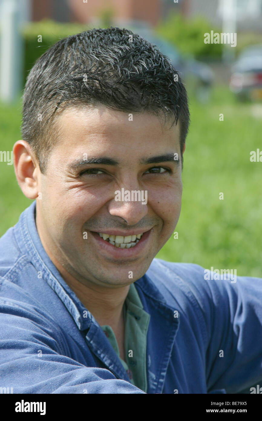 Foreign worker with stubbly beard happy look at the camera Stock Photo