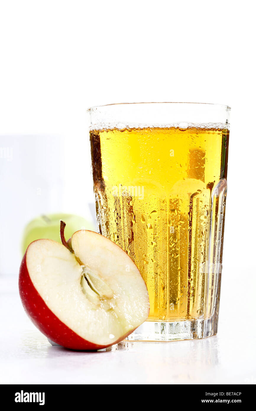 Glass of apple juice with half an apple in front Stock Photo