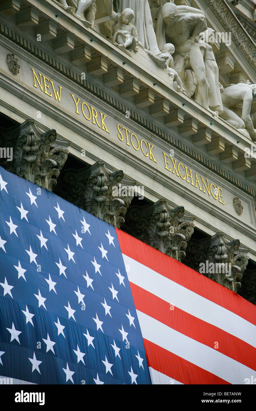 View of the New York Stock Exchange decorated with  a flag of the United States of America near Wall Street in New York Stock Photo