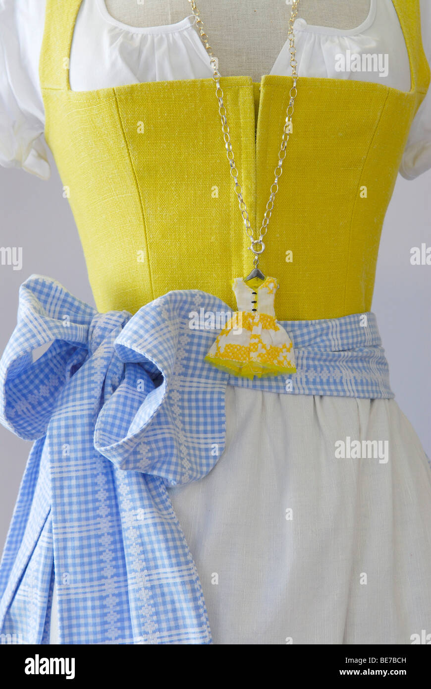 Dirndl dress with matching dirndl-dress-pendant as a chain Stock Photo