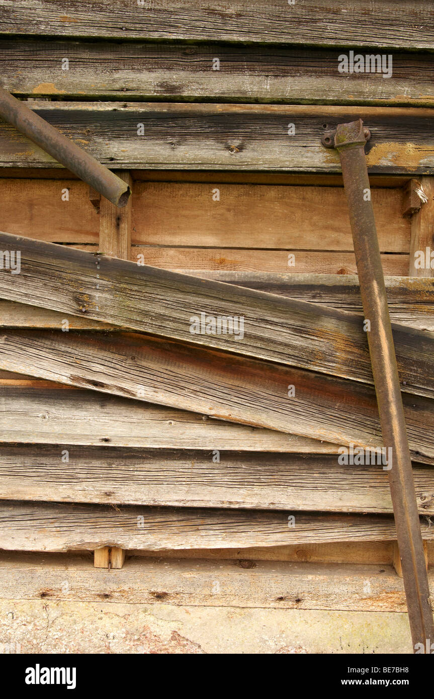 Planks falling of a derelict bar with broken cast iron drain pipes