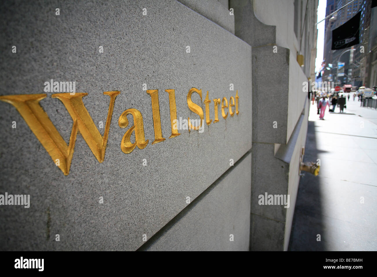Golden Wall street sign carved on a wall in the financial district area of downtown Manhattan in New York city, united states. Stock Photo