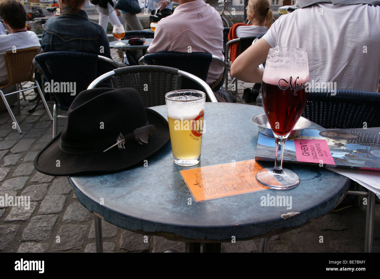 Beer, Graslei, Gent, Belgium pub table drinks glasses black trilby hat Stock Photo