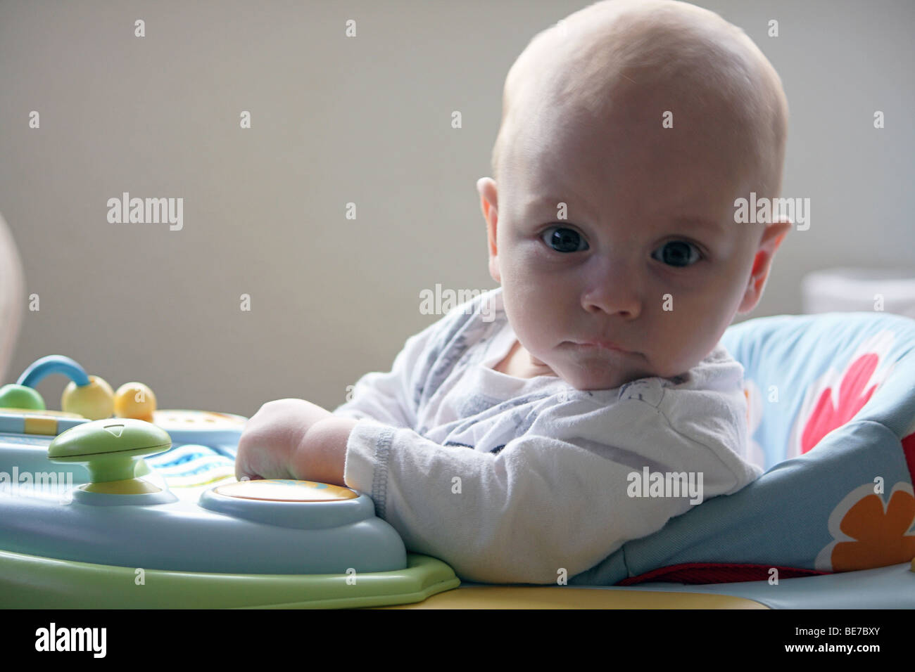 A newborn baby boy playing in his walker toy Stock Photo - Alamy