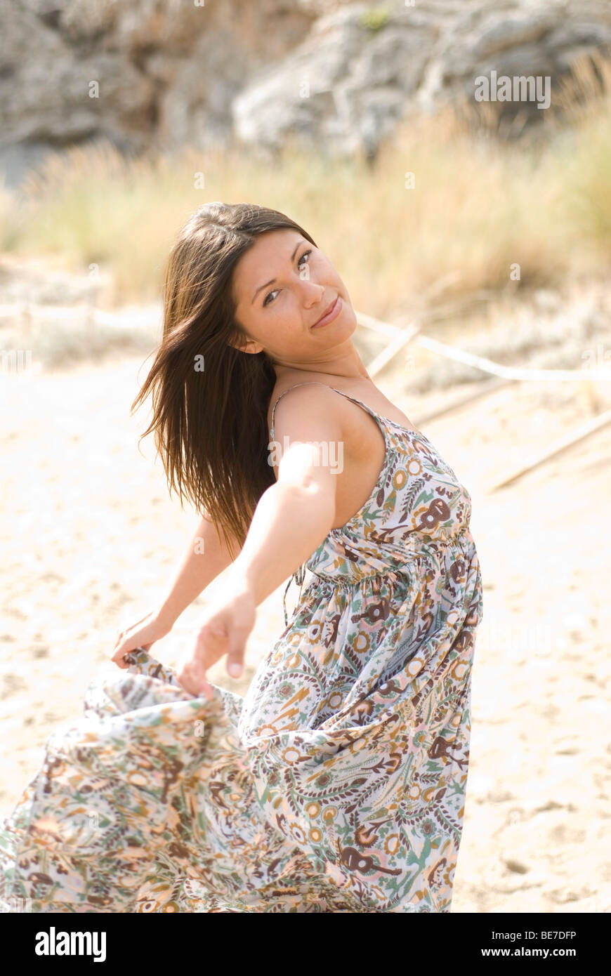 Young woman dancing on the beach and moving her dress Stock Photo - Alamy
