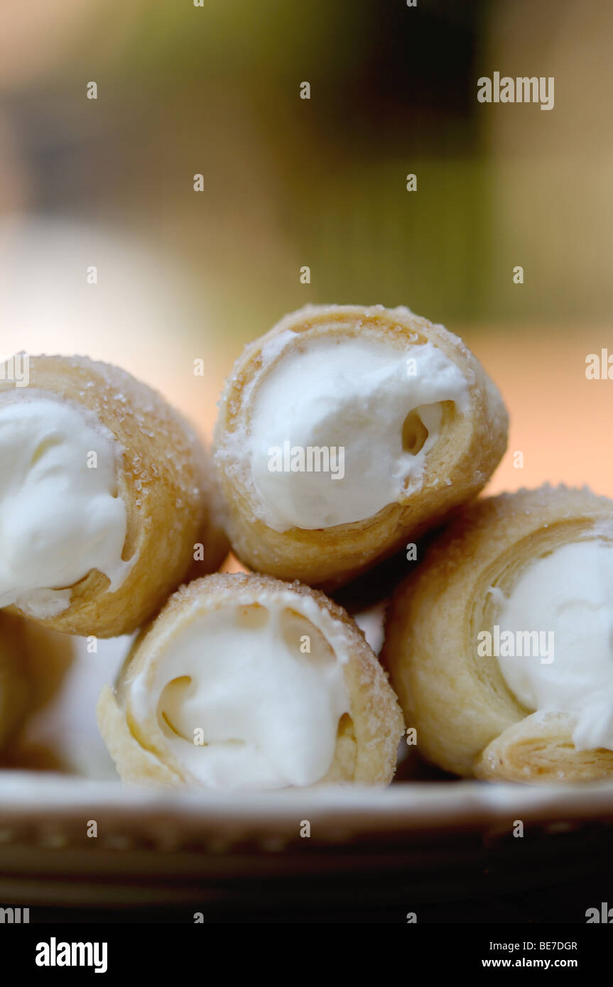 Fresh rolled crispy cookies with cream Stock Photo