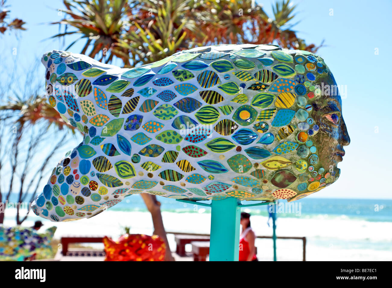 fish and face Sculpture on display by the ocean at a arts festival Stock Photo