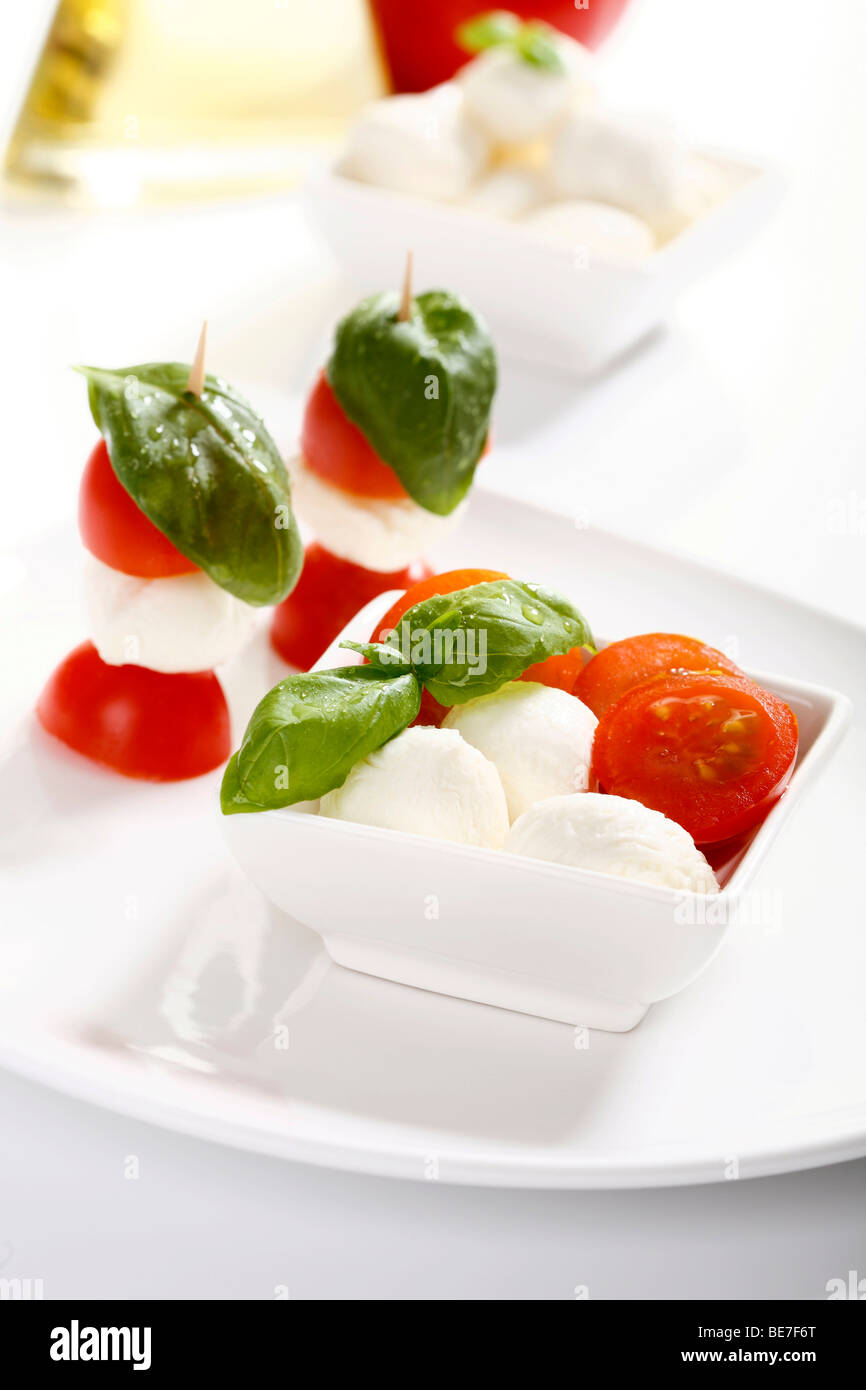 Tomato-mozarella sticks with basil in a bowl Stock Photo