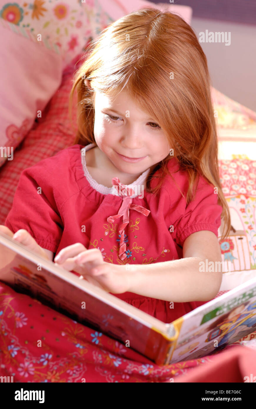 Little girl reading a picture book Stock Photo
