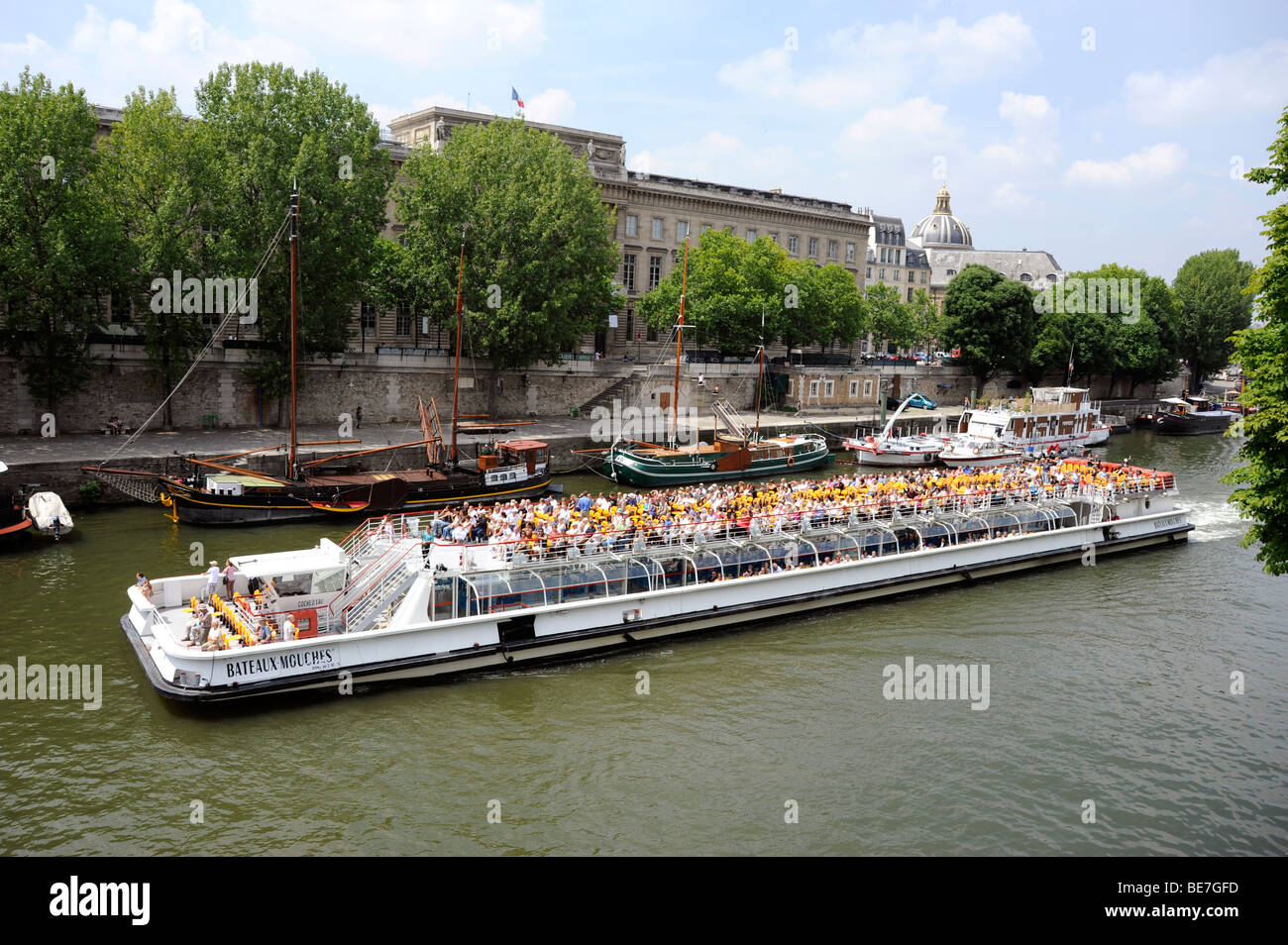 Bateau Mouche On The Seine River And Hotel Des Monnaies Paris France Stock Photo Alamy