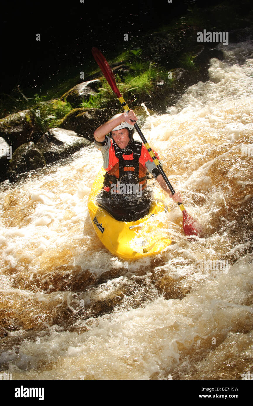 A man kayaking on the Tryweryn river, National White Water Centre, canoeing watersports near Bala Gwynedd north wales UK Stock Photo