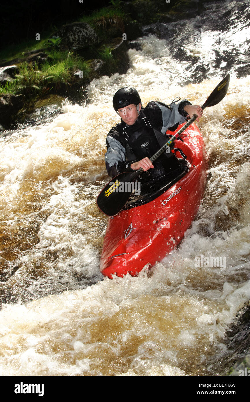 A person kayaking on the Tryweryn river, National White Water Centre, canoeing watersports near Bala Gwynedd north wales UK Stock Photo