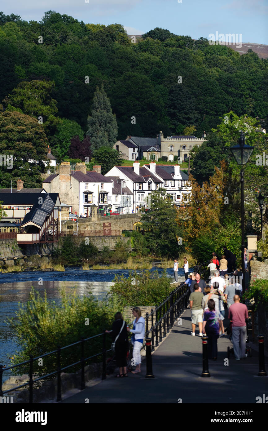 People walking on a Sunday afternoon along the Riverside park on the banks of the River Dee in Llangollen town, north wales UK Stock Photo