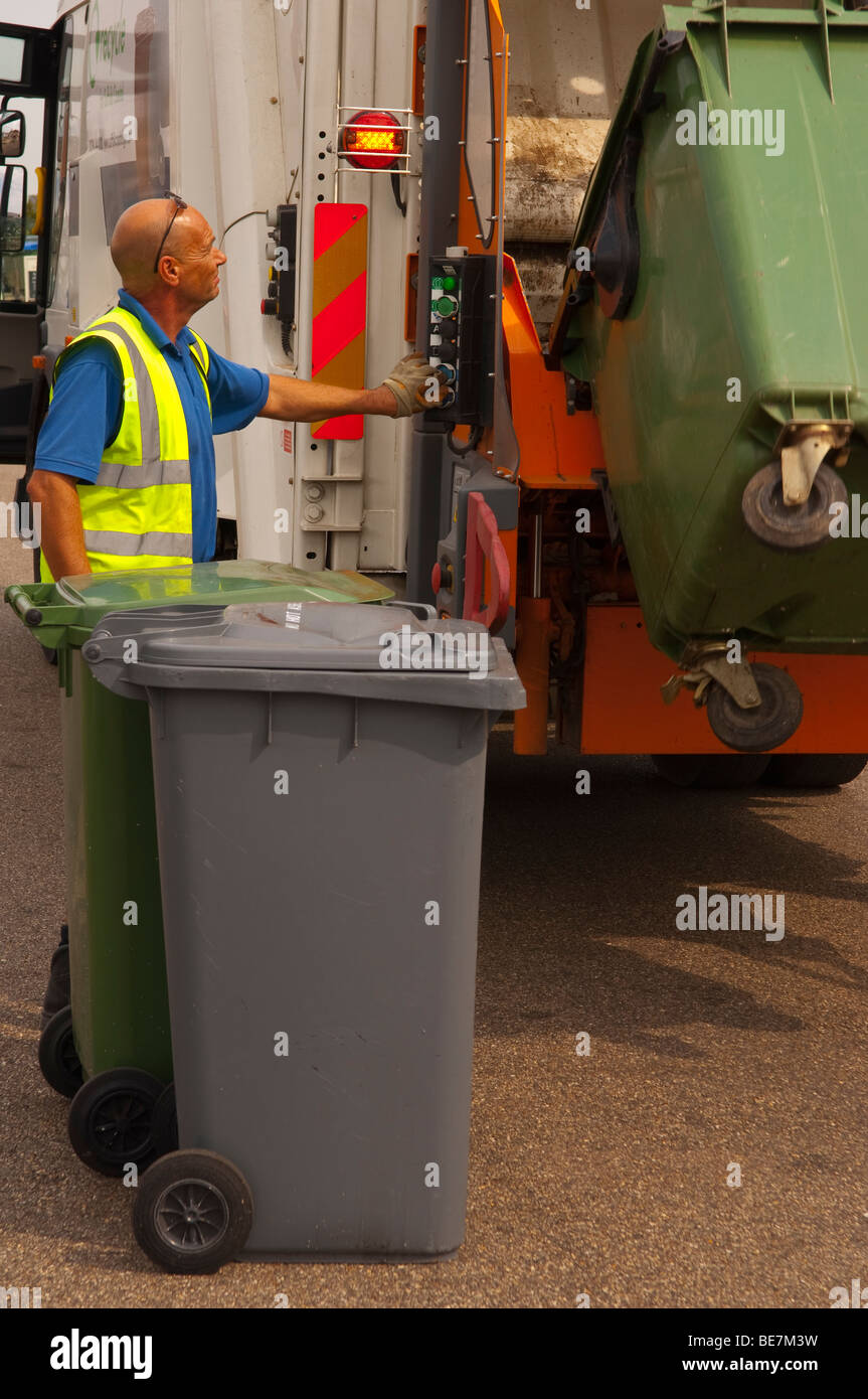 A binman emptying a wheelie bin in the bin lorry in the Uk Stock Photo