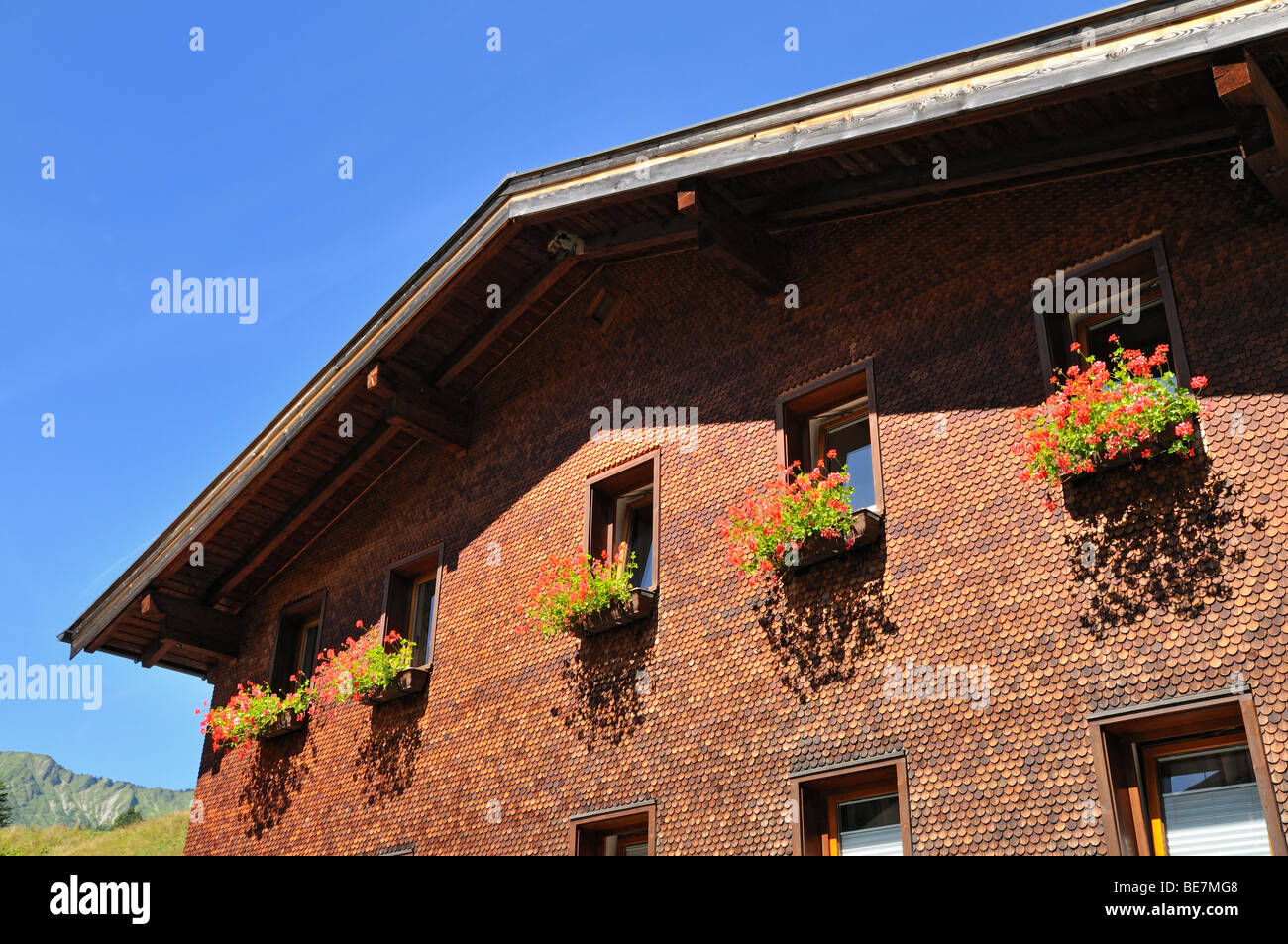 House facade with flowers in Baad, Kleinwalsertal valley, Vorarlberg, Allgaeu Alps, Austria Stock Photo