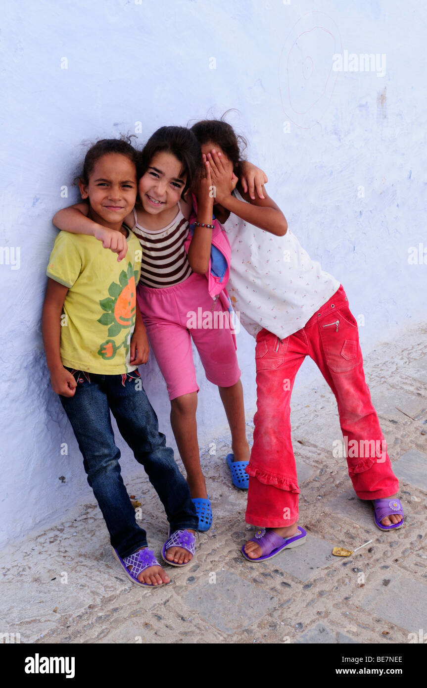 Morocco; Chefchaouen; Three moroccan  girls with differing facial expressions  in the Medina Stock Photo