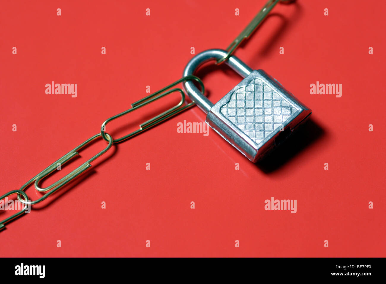 Padlock connecting paperclip chain close up Stock Photo
