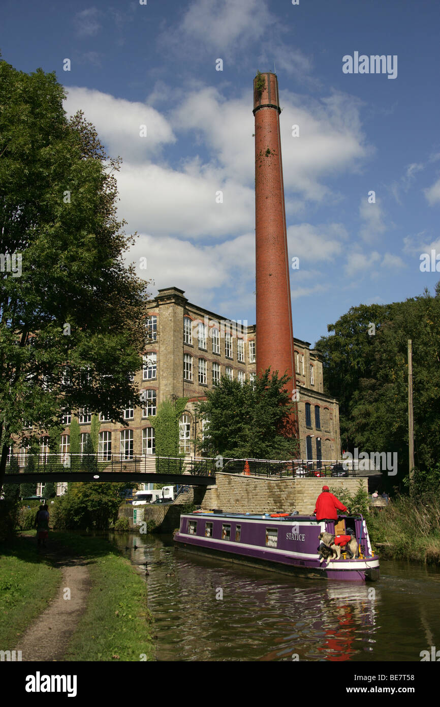 Town of Bollington, England. View of a canal boat on Macclesfiled Canal at Bollington, with Clarence Mill in the background. Stock Photo