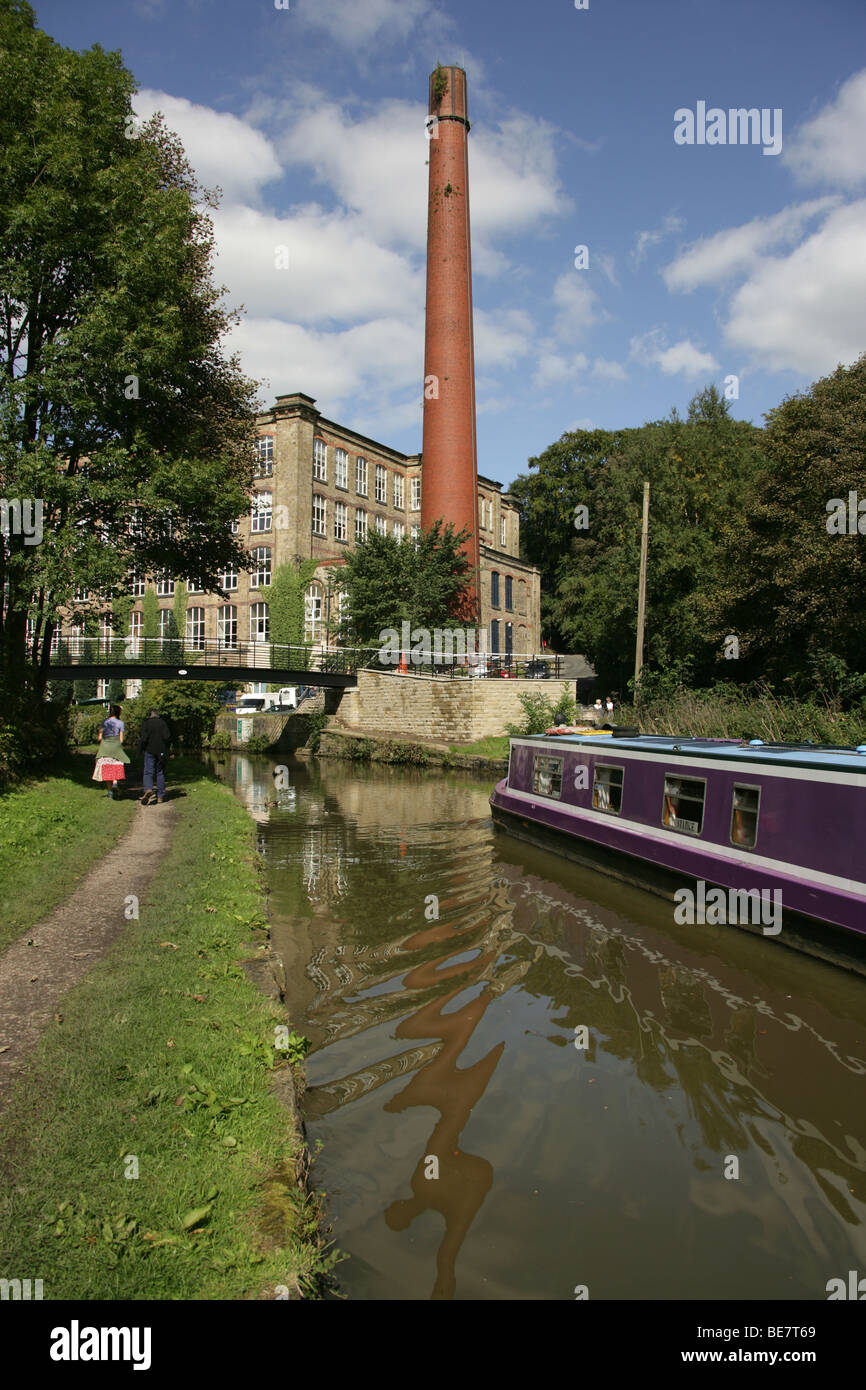 Town of Bollington, England. View of a canal boat on Macclesfiled Canal at Bollington, with Clarence Mill in the background. Stock Photo