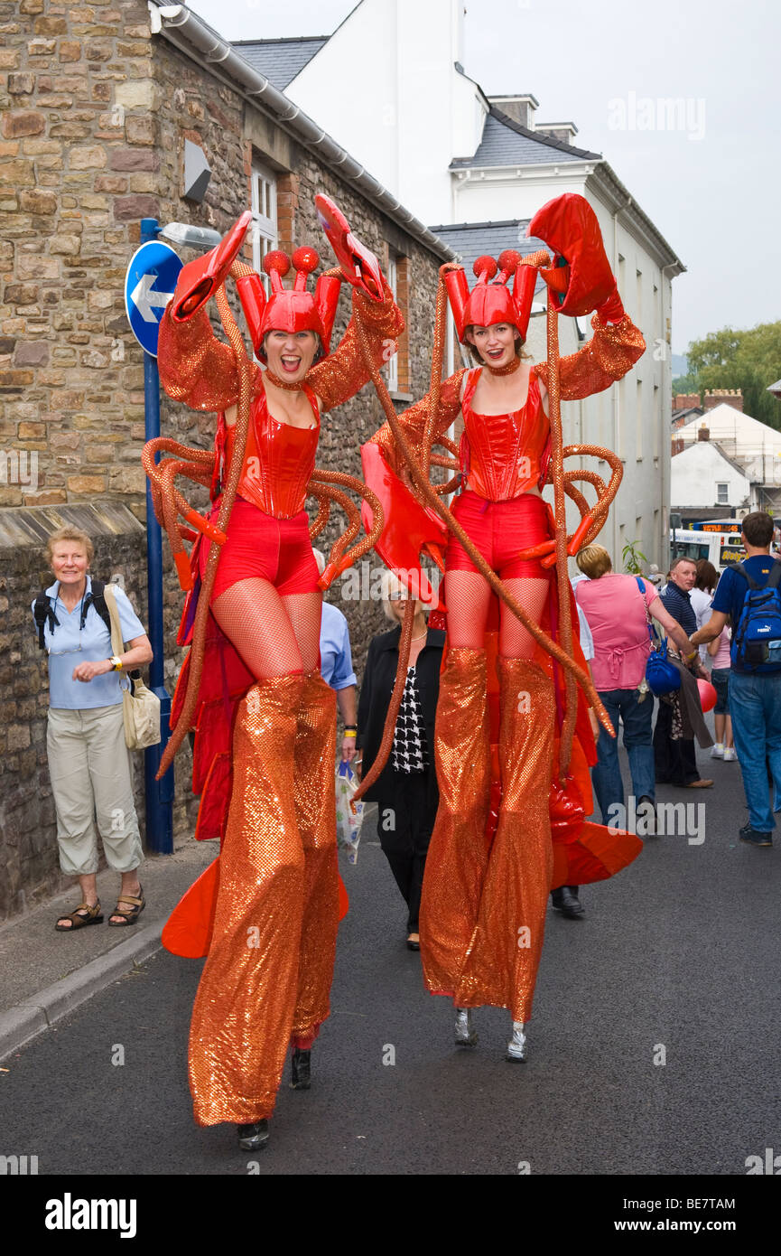 Stilt walking street performance artists dressed as lobsters at