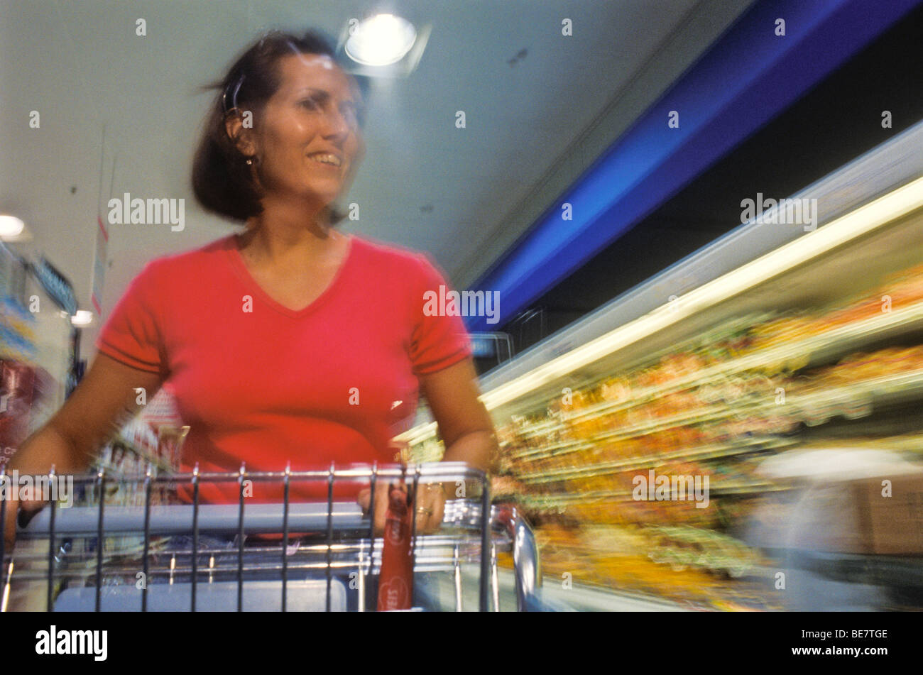 One female woman rushing through weekly family shopping chores. motion ...