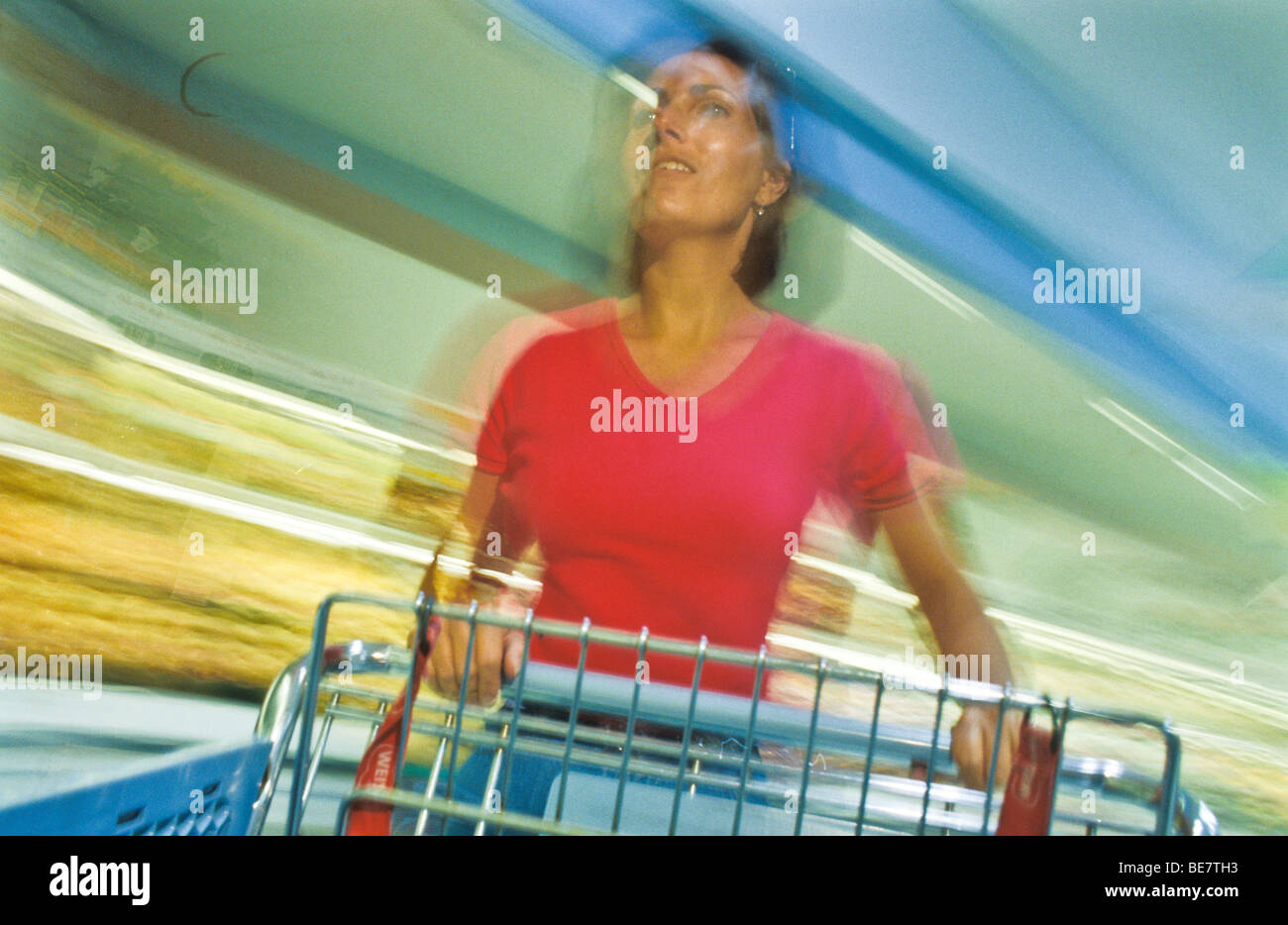 One female woman rushing through weekly family shopping chores. motion ...