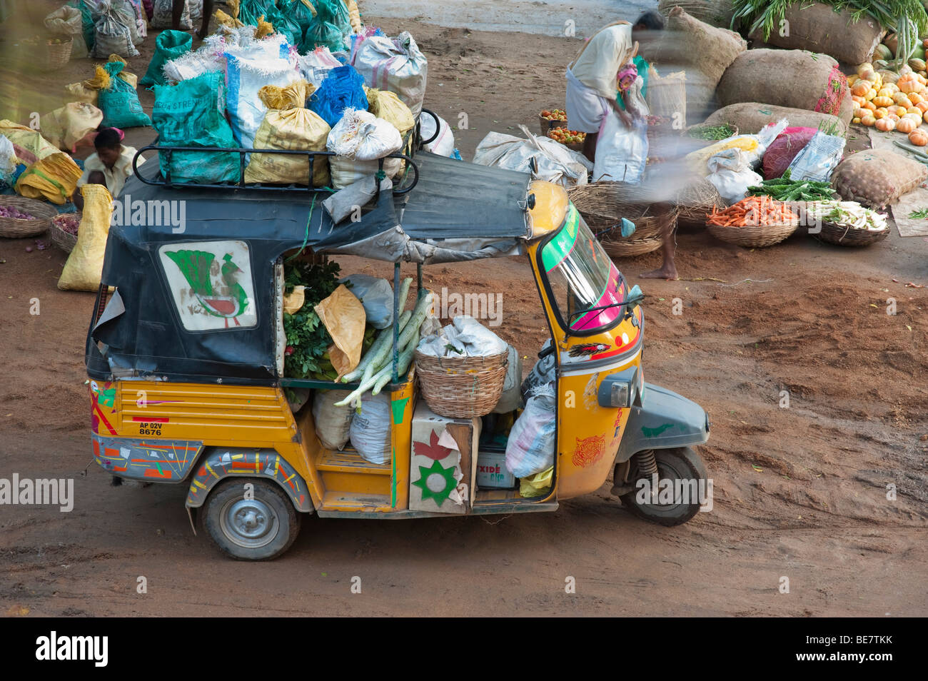 Auto rickshaw carrying goods to an Indian street market in Puttaparthi, Andhra Pradesh, India Stock Photo