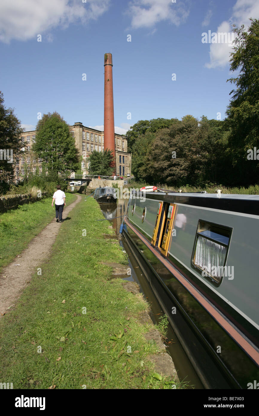 Town of Bollington, England. Canal boats berthed on Macclesfiled Canal at Bollington, with Clarence Mill in the background. Stock Photo