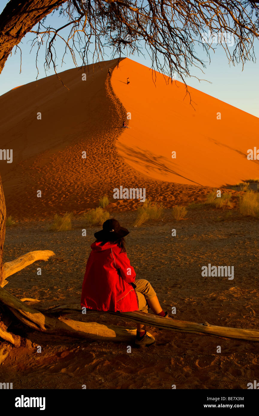Tourist at Dune 45 at sunset at Sossusvlei, Namib Naukluft National ...