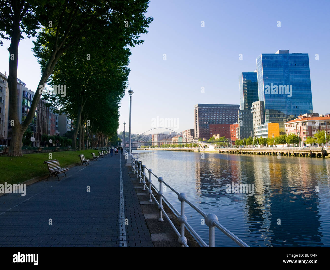Urban renewal along the Nervion River and the Paseo Campo de Volantin in Bilbao, Spain. Zubizuri footbridge is in the distance. Stock Photo