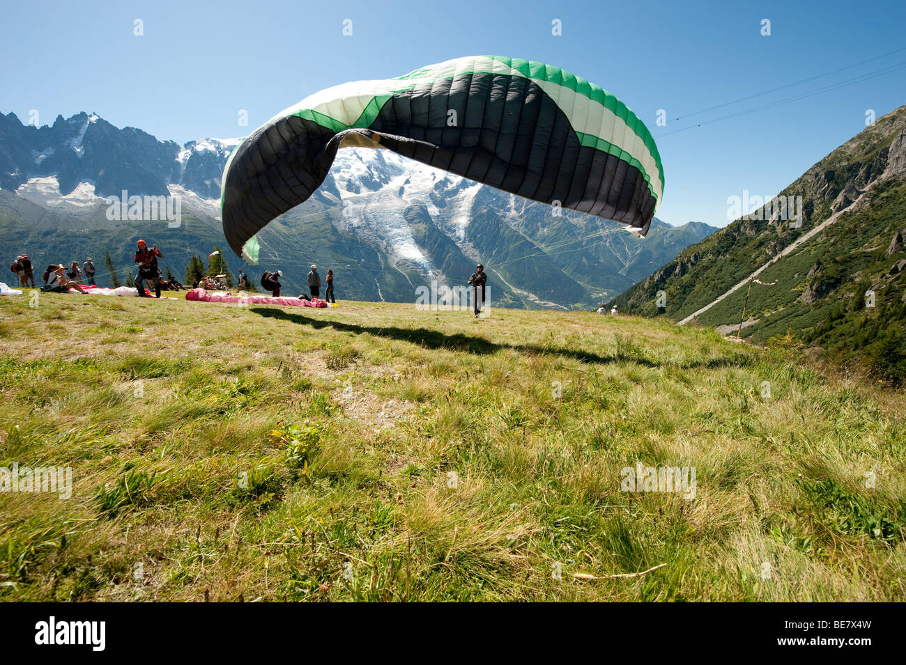 Paraglider pilots prepare for take off from Brevent, in the Chamonix Valley opposite the Mont Blanc Massif, France. Stock Photo