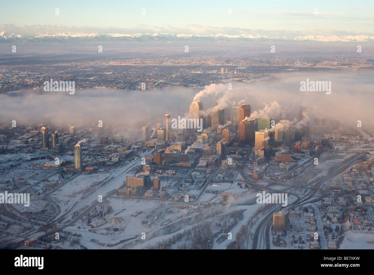 Emissions from downtown buildings in a city during cold weather Stock Photo