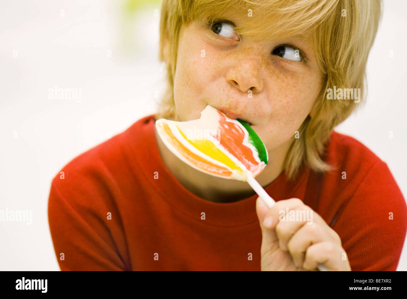 Boy eating lollipop Stock Photo