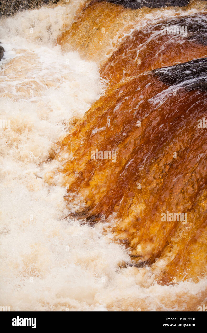 Aysgarth Falls at Aysgarth in the yorkshire Dales National Park, UK. The water is stained orange by its load of peat Stock Photo