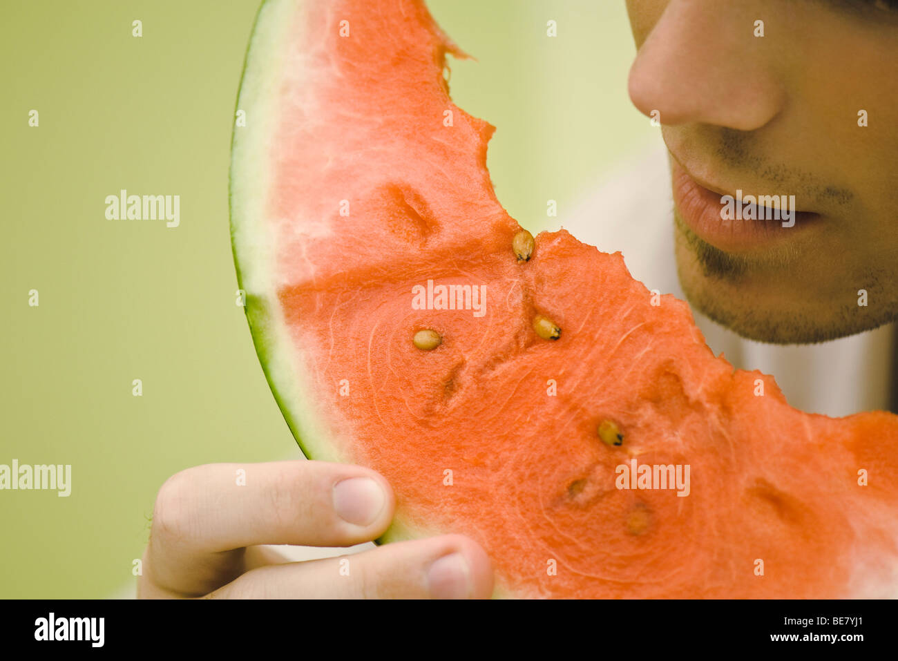 You man eating slice of watermelon Stock Photo