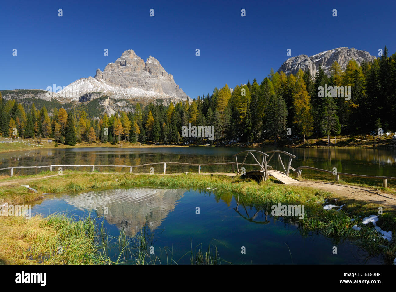 Drei Zinnen above lake Antornosee with path with bridge, Dolomites, South Tyrol, Italy Stock Photo