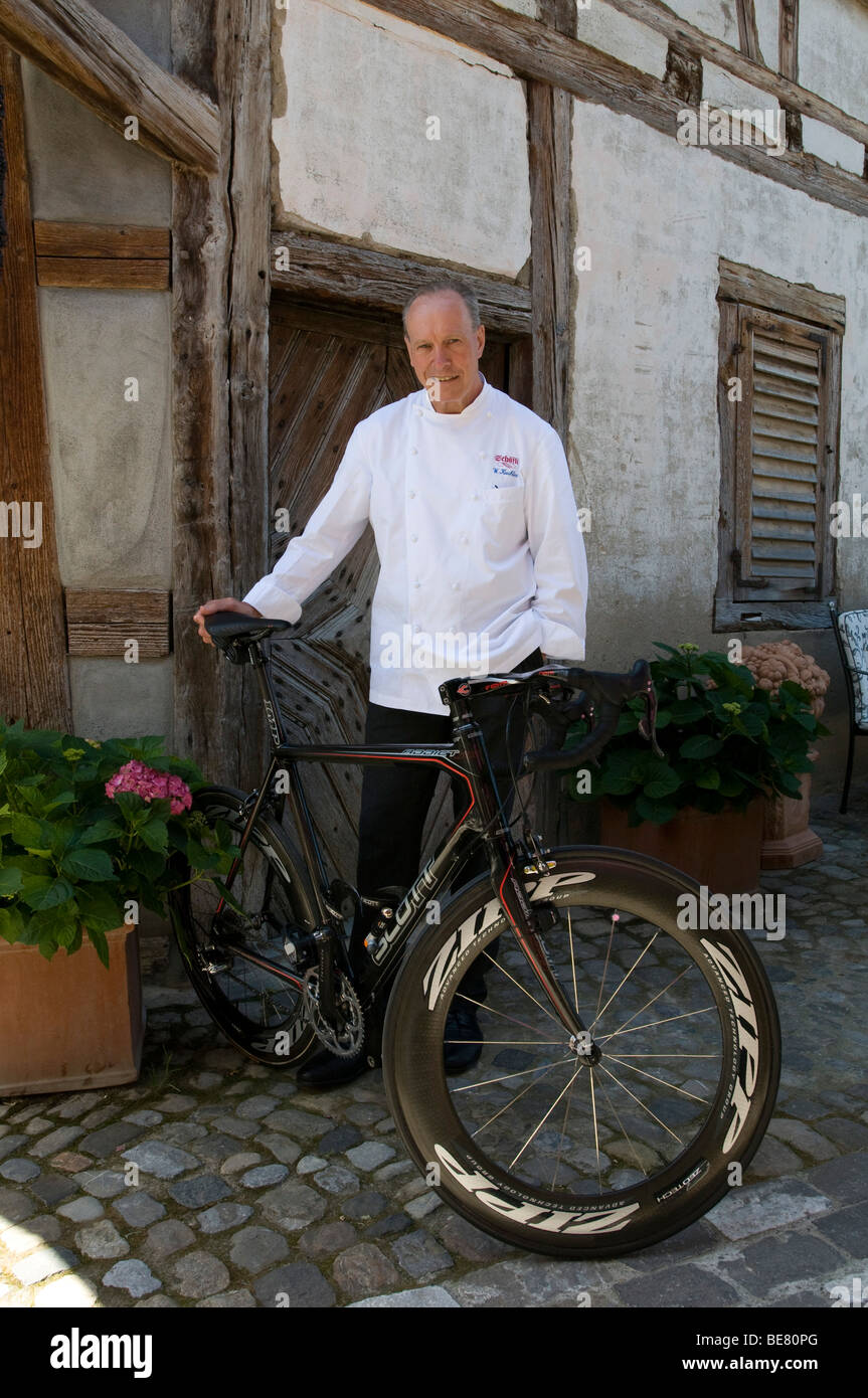 Restaurant Taverne Zum Schaefli, Owner and head chef Wolfgang Kuchler with racing bike, Wigoltingen, Lake Constance, Switzerland Stock Photo