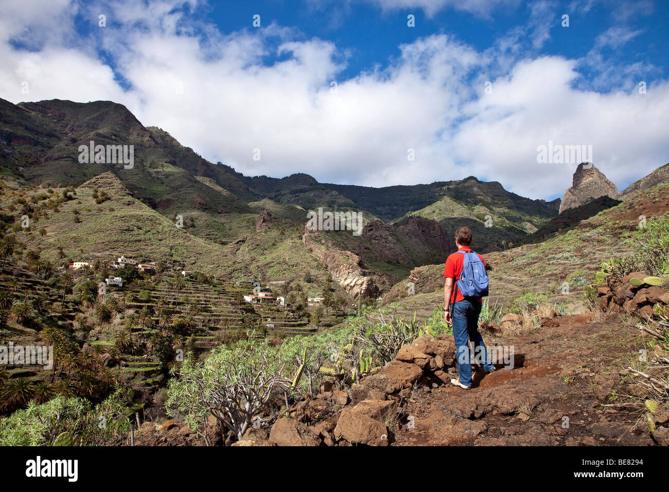 Hiker in the mountains looking at the view, Roque de Agando, La Gomera, Canary Islands, Spain, Europe Stock Photo