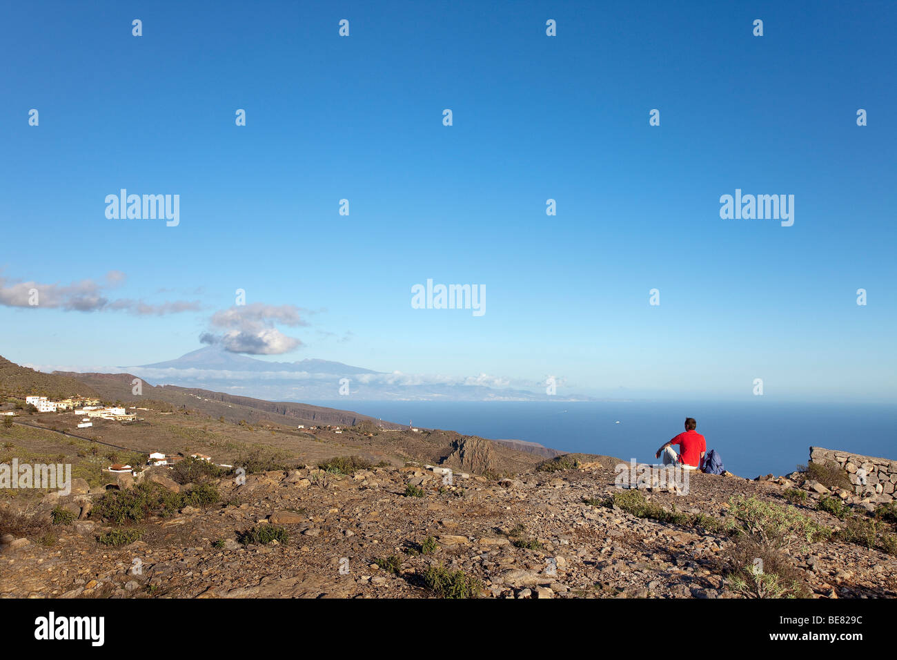 Hiker looking at the view at Teide volcano and at the sea, La Gomera, Canary Islands, Spain, Europe Stock Photo