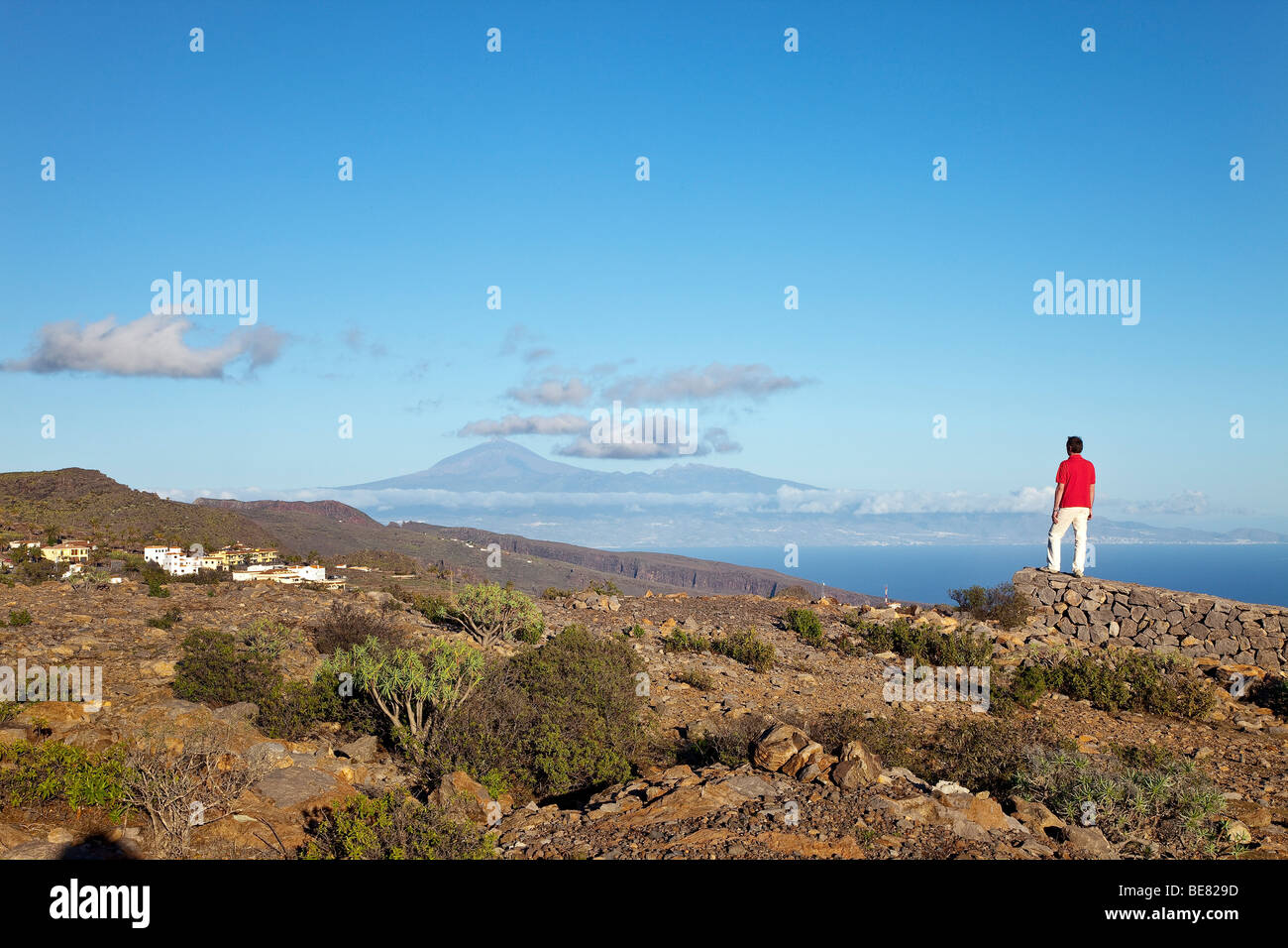 Hiker looking at view at Teide volcano and at the sea, La Gomera, Canary Islands, Spain, Europe Stock Photo