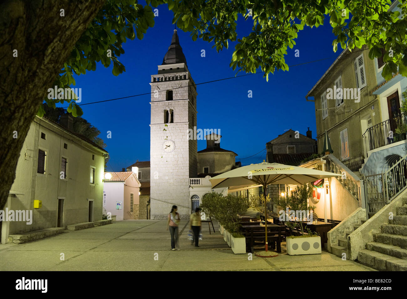 A couple strolling over the market place in the evening, Omisalj, Krk Island, Istria, Croatia, Europe Stock Photo