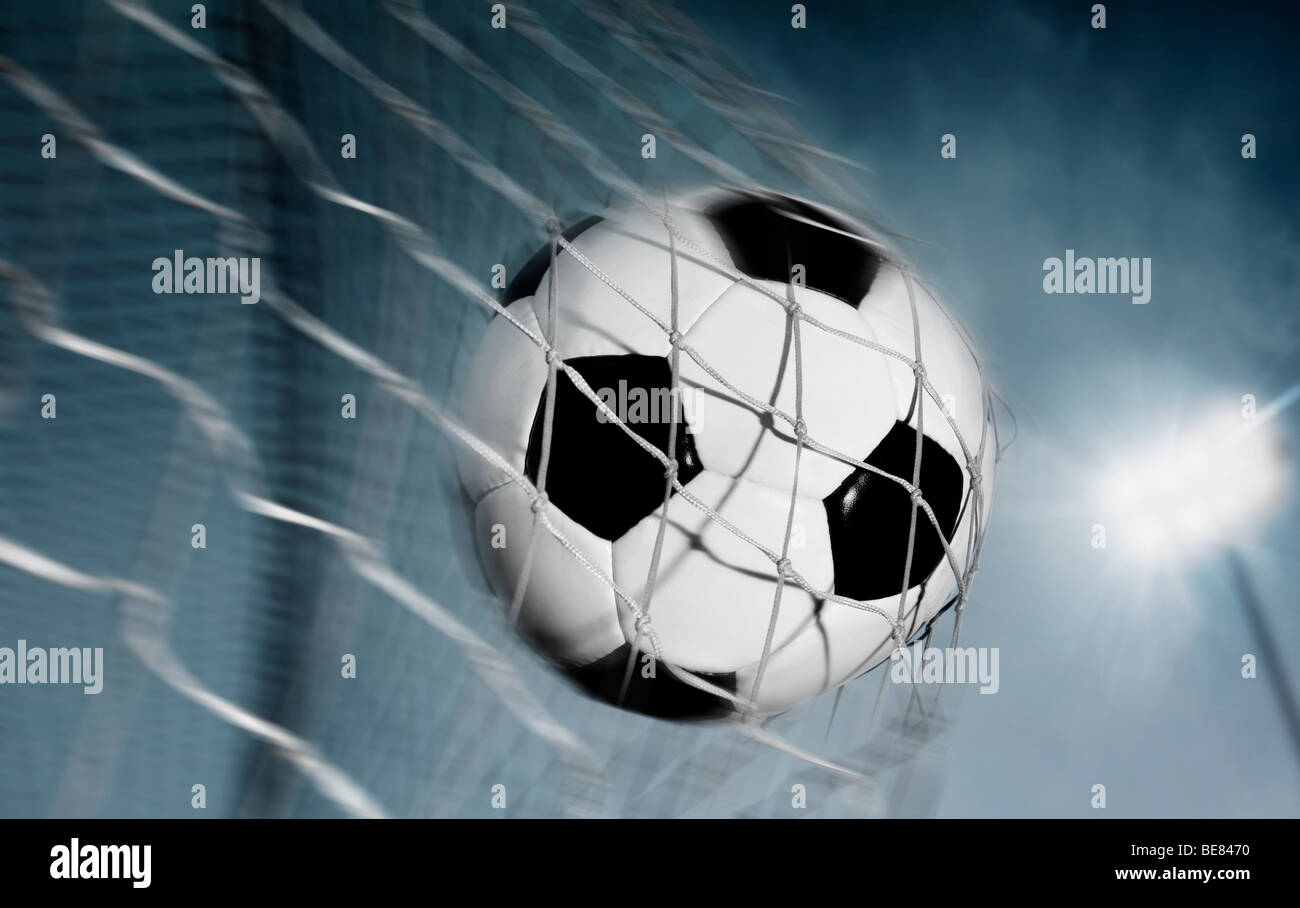 Soccer ball kicked into the back of a goal Stock Photo Alamy