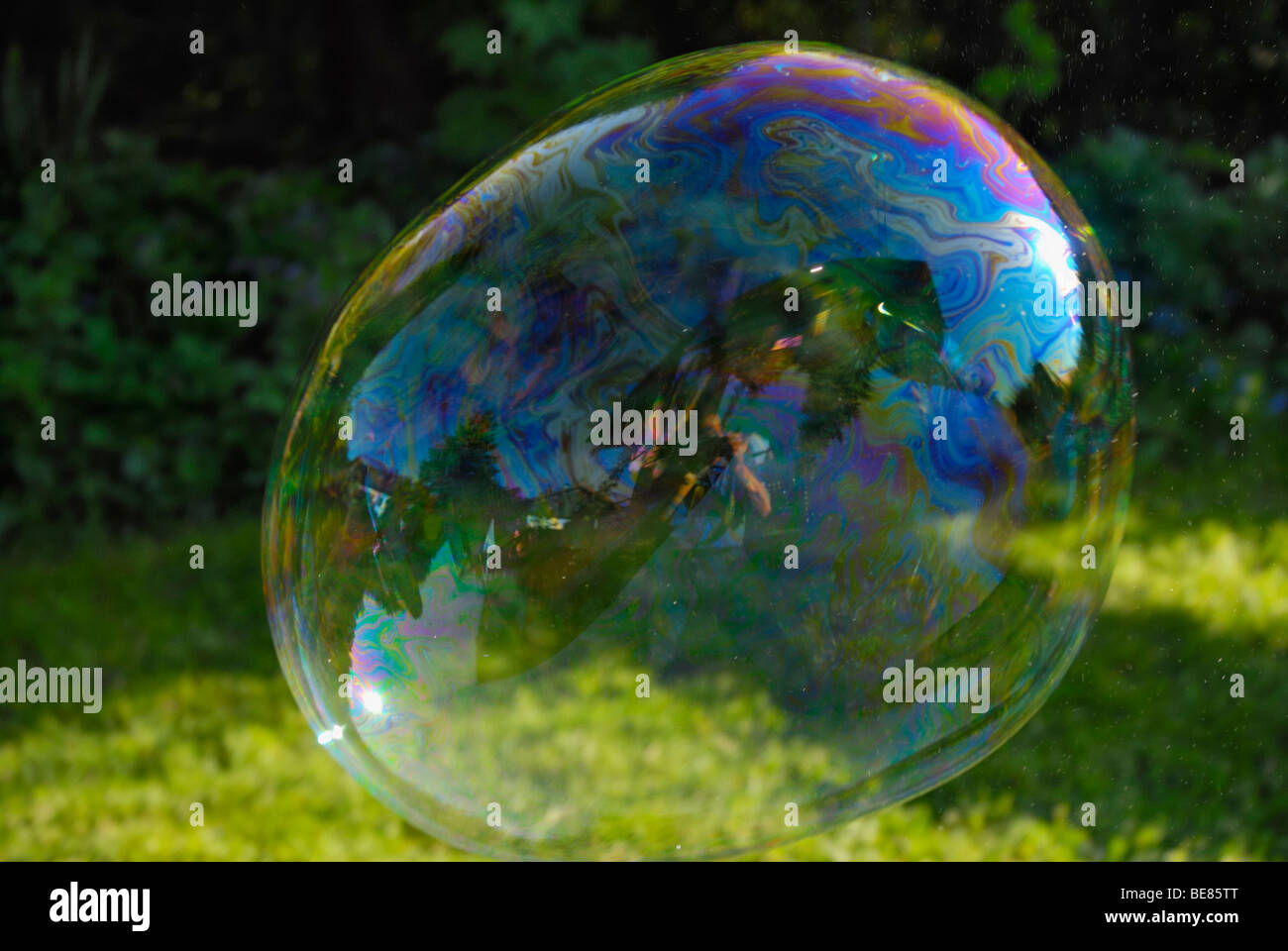 Reflections in a large soap bubble Stock Photo