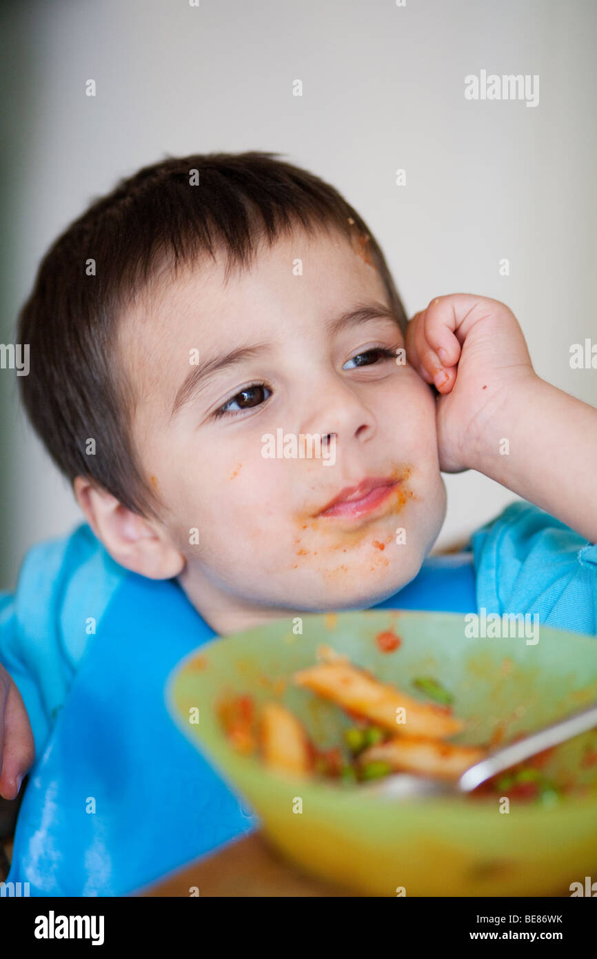3-year-old-boy-leaning-on-his-elbow-at-dinner-table-stock-photo-alamy