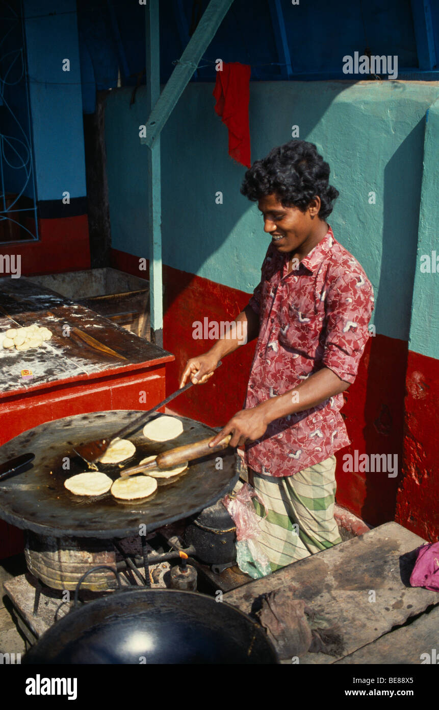 BANGLADESH South Asia Khulna Barisal Man Cooking breads on hotplate
