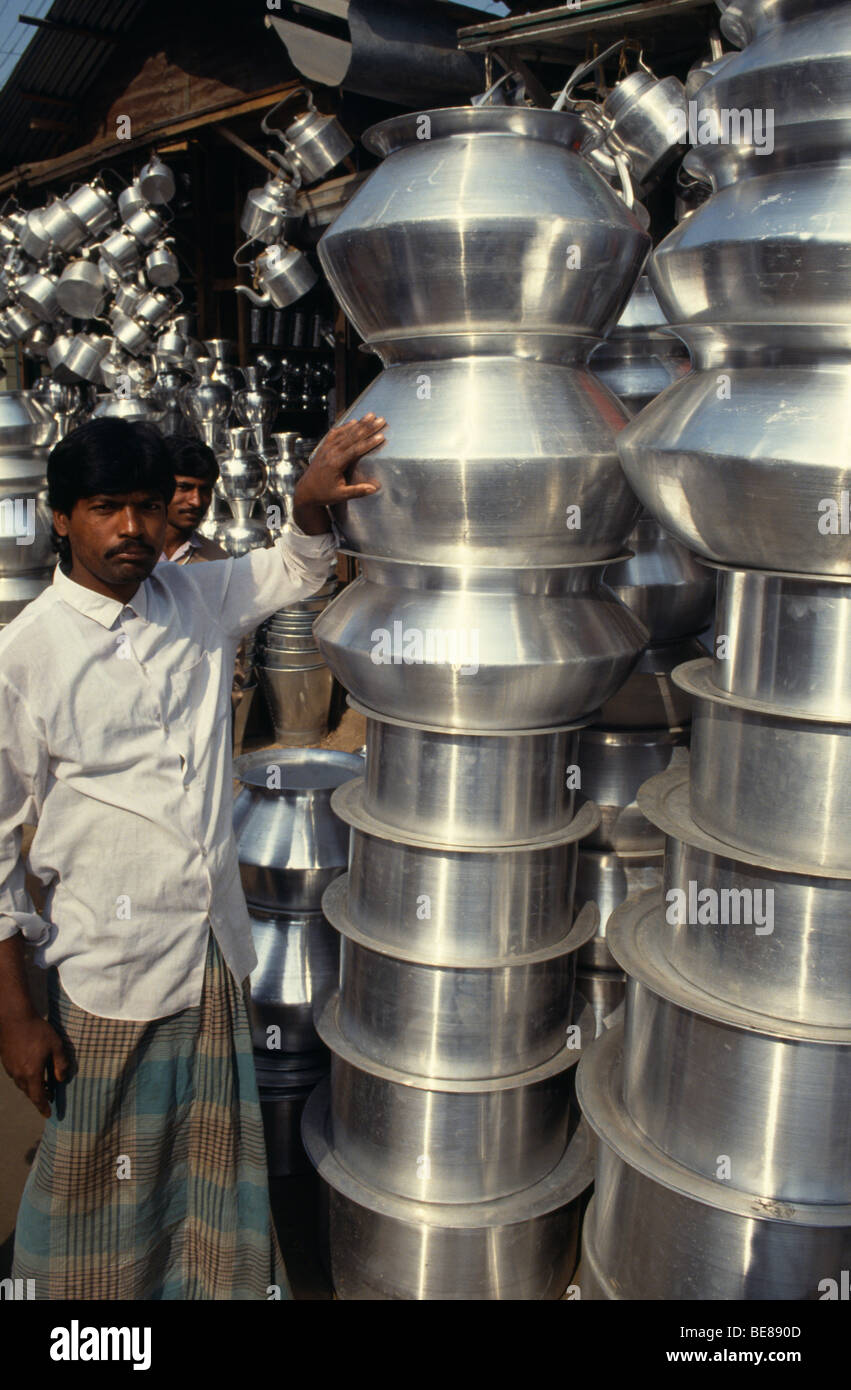 https://c8.alamy.com/comp/BE890D/bangladesh-dhaka-vendor-standing-beside-stack-of-aluminum-pots-and-BE890D.jpg