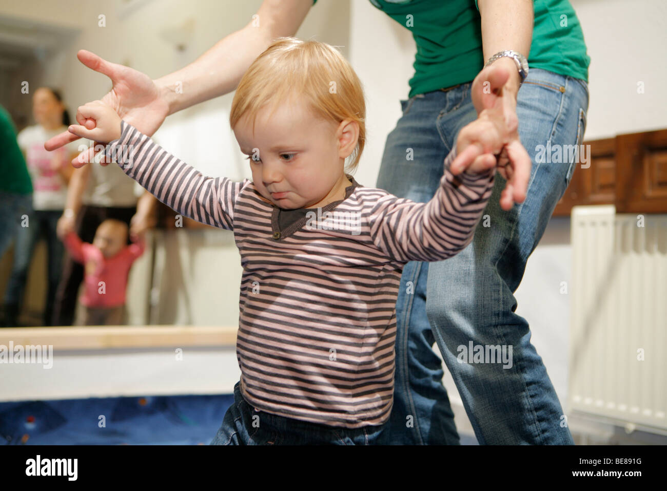 Mothers and children in baby center playing music. Baby music. Stock Photo