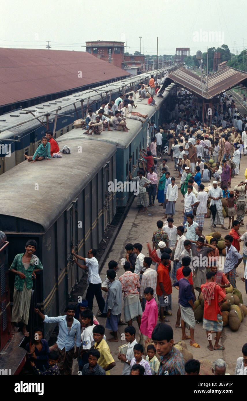 BANGLADESH Bramanbahria Railway Station Train loaded with passengers with crowds on the platform and people sitting on roof Stock Photo