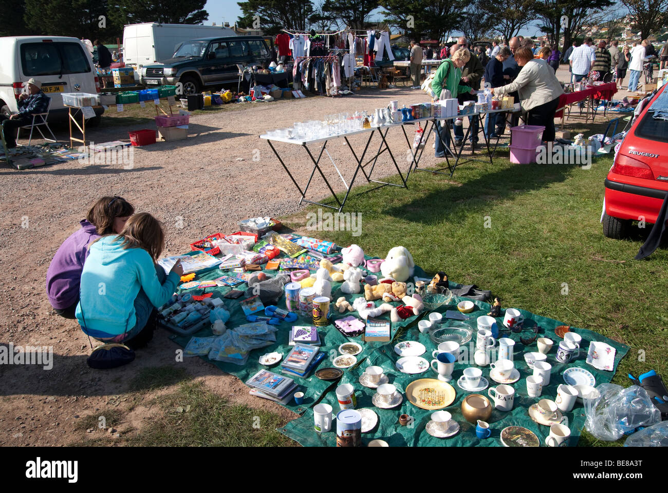 Traders and customers at a Sunday car boot sale in West Bay, Dorset